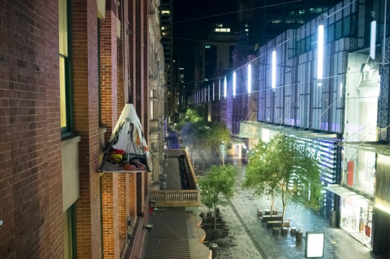 Woman camps overnight in tent hanging off building to mark opening of Icebreaker store