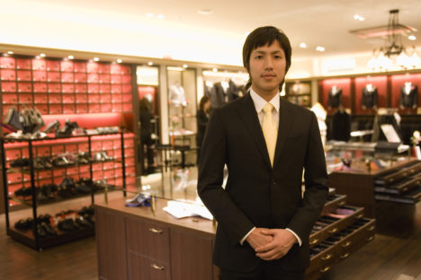 Male salesclerk at men's clothing counter
