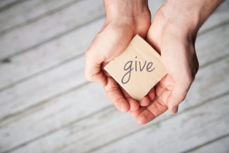 Two hands offering to give, donate or charity