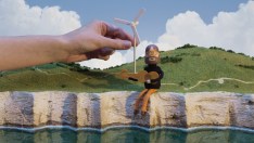 A 'man' strums a banjo while a wind turbine is placed behind him